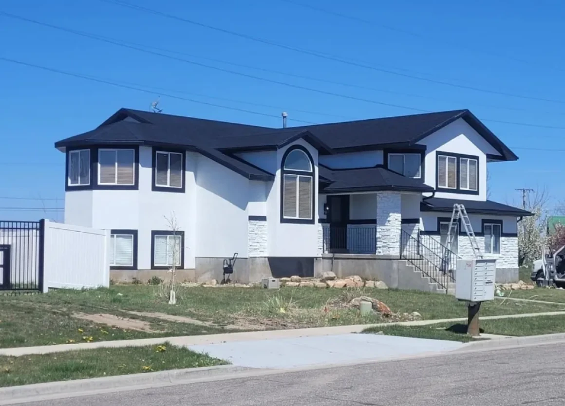 Modern two-story house with black roof.