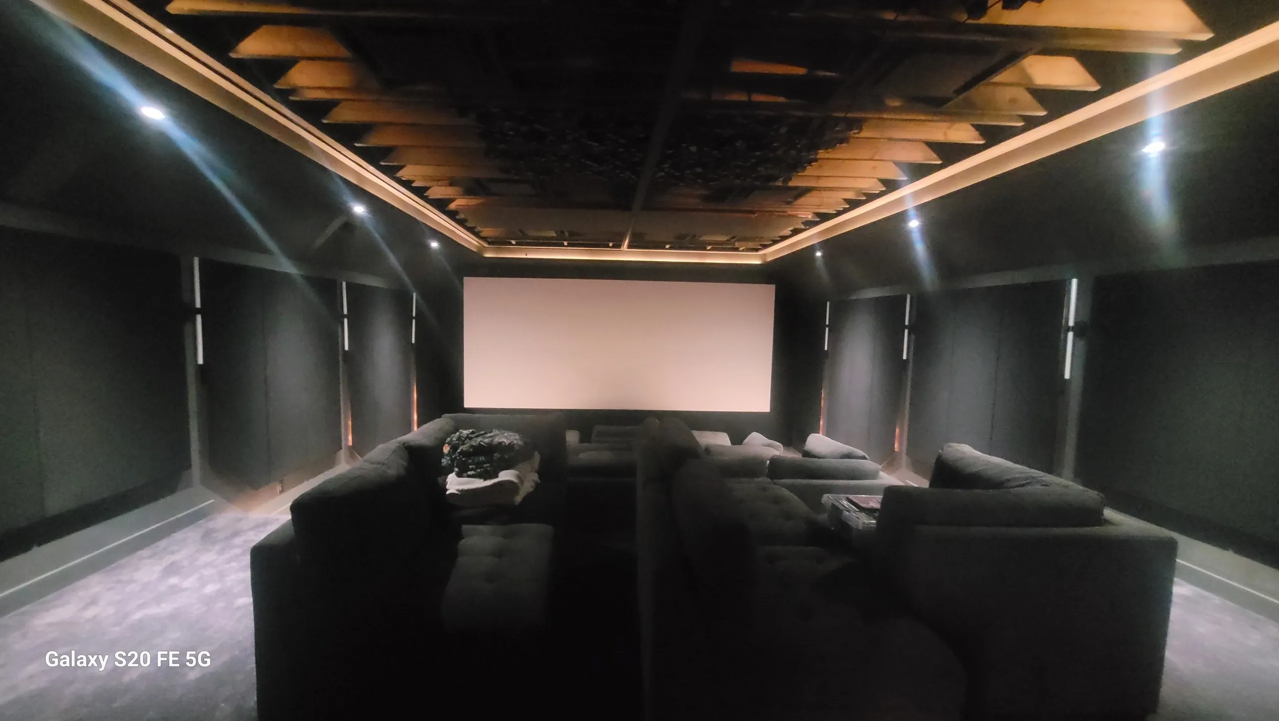 Home theater room with large screen.