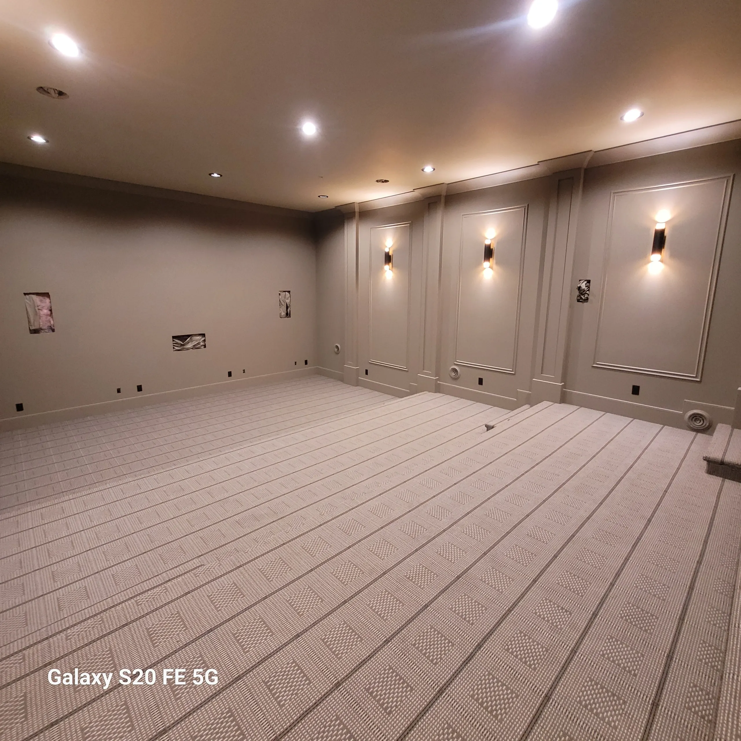 Empty room with recessed lighting and carpet.