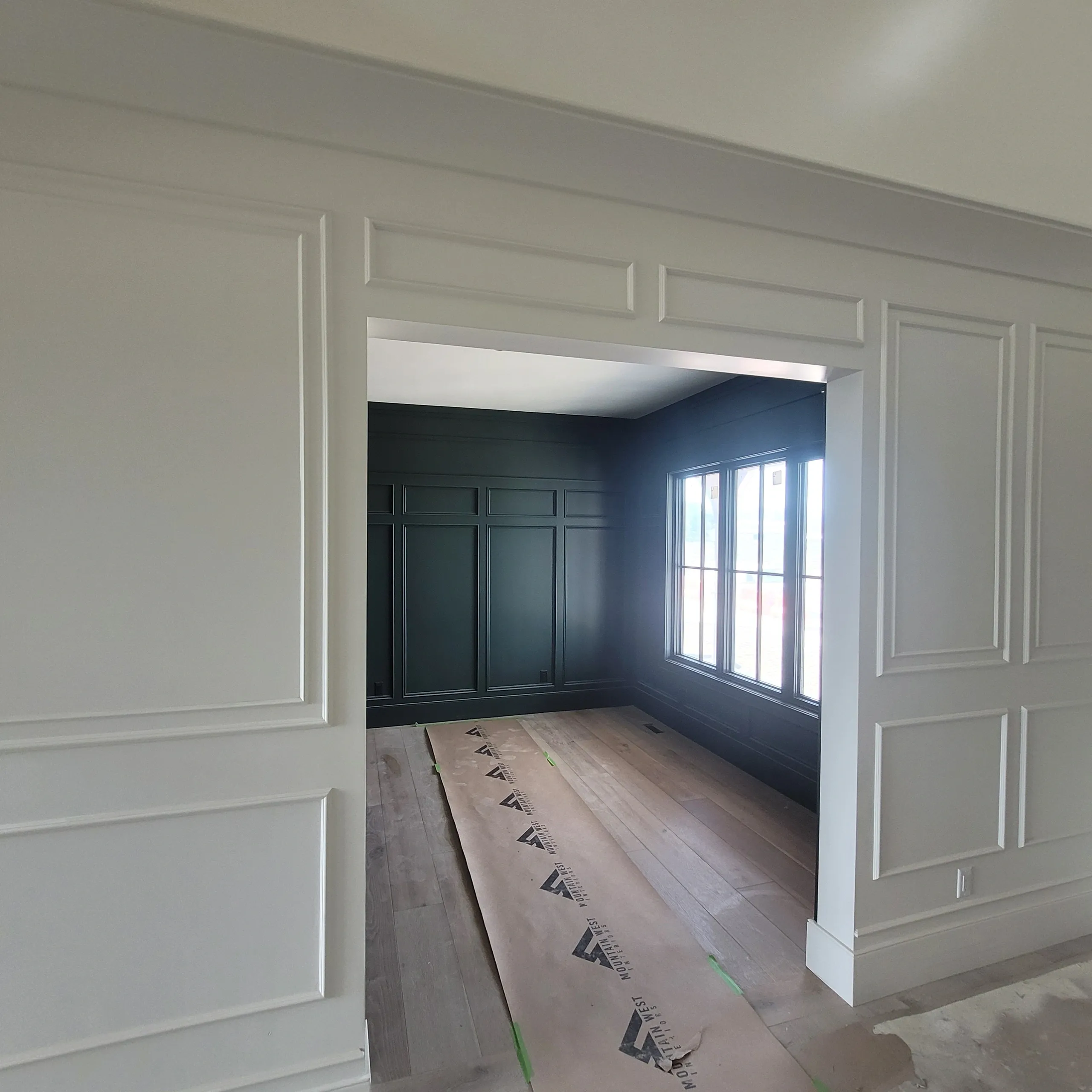 Empty room with large window and molding.